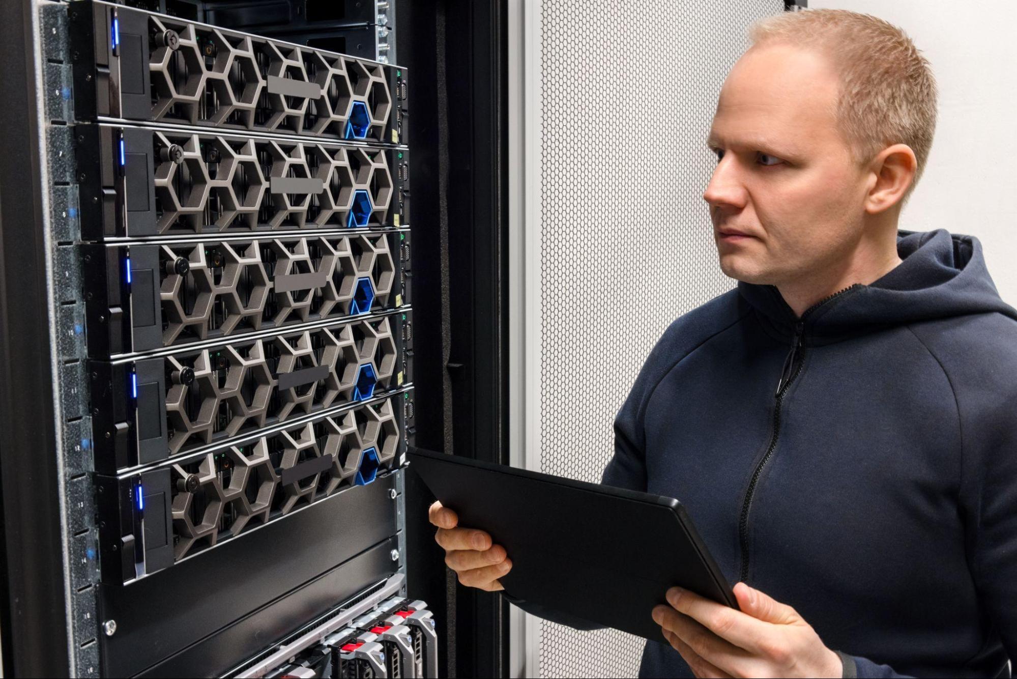 A IT professional working to enhance data center efficiency with advanced digital tools.