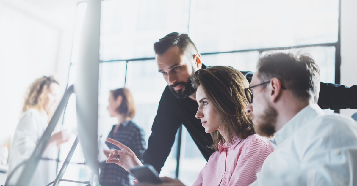 IT staff analyzing cybersecurity data on a flatscreen monitor