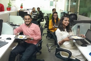 ConnectWise employees smiling and eating at their desks