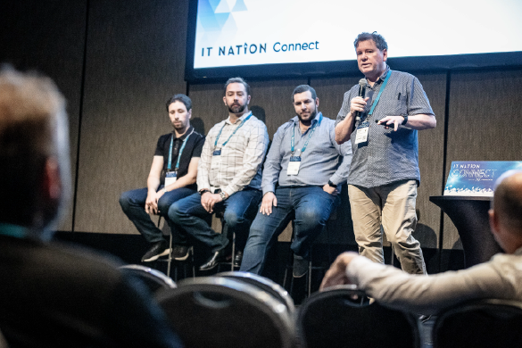 speaker panel presenting to crowd